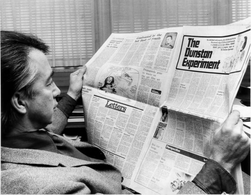 Don Dunstan reading a newspaper