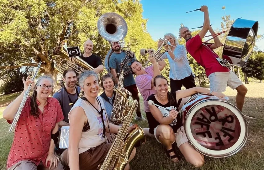 Cropped group profile photo of Riff Raff Radical Marching Band Magandjin/Brisbane crew with their instruments in a park