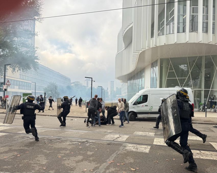 cops running with shields and batons and tear gas
