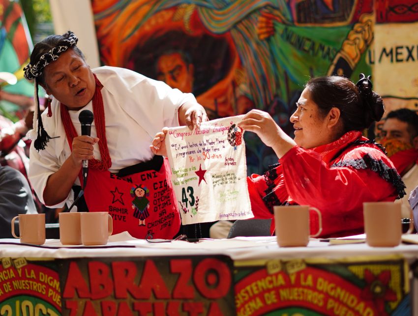 Man and woman holding a small cloth banner