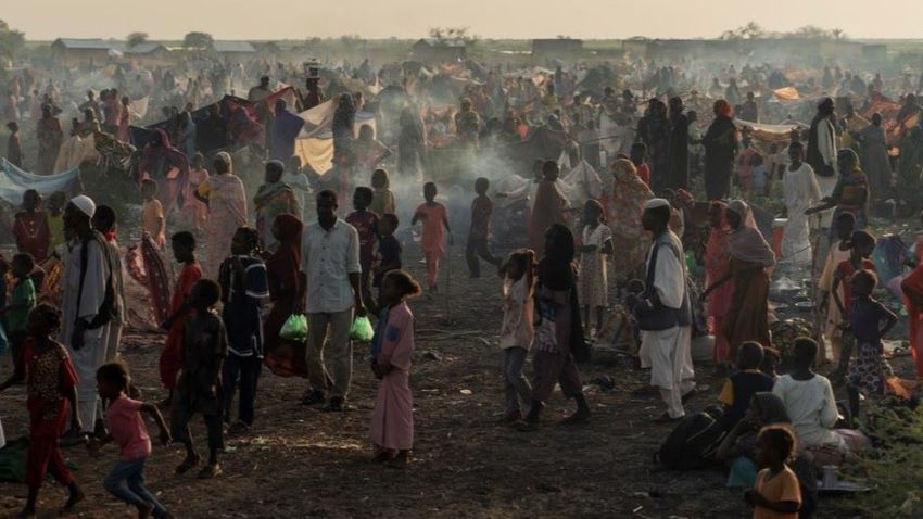 people arriving at a refugee camp