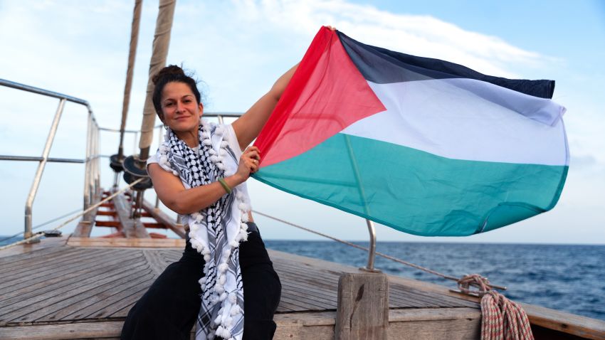 Woman on boat with Palestinian flag
