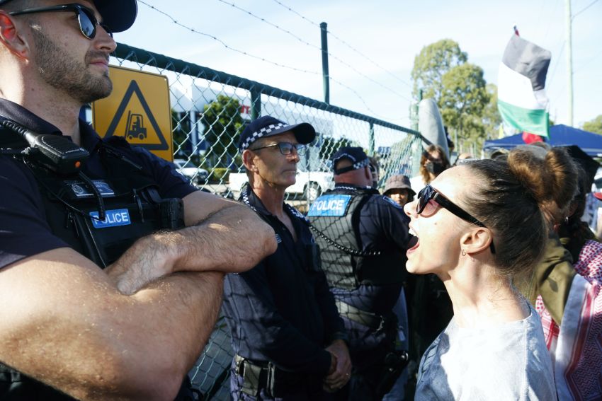 Confronting police outside Ferra Engineering