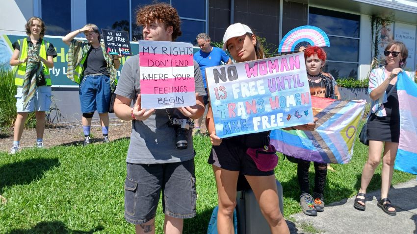 Protesters with pro-trans rights signs