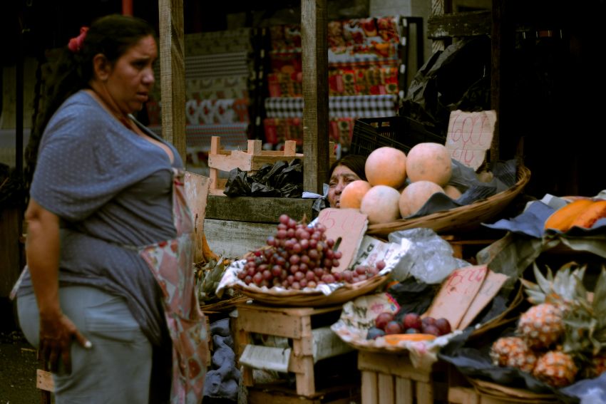 woman standing in front of a stall
