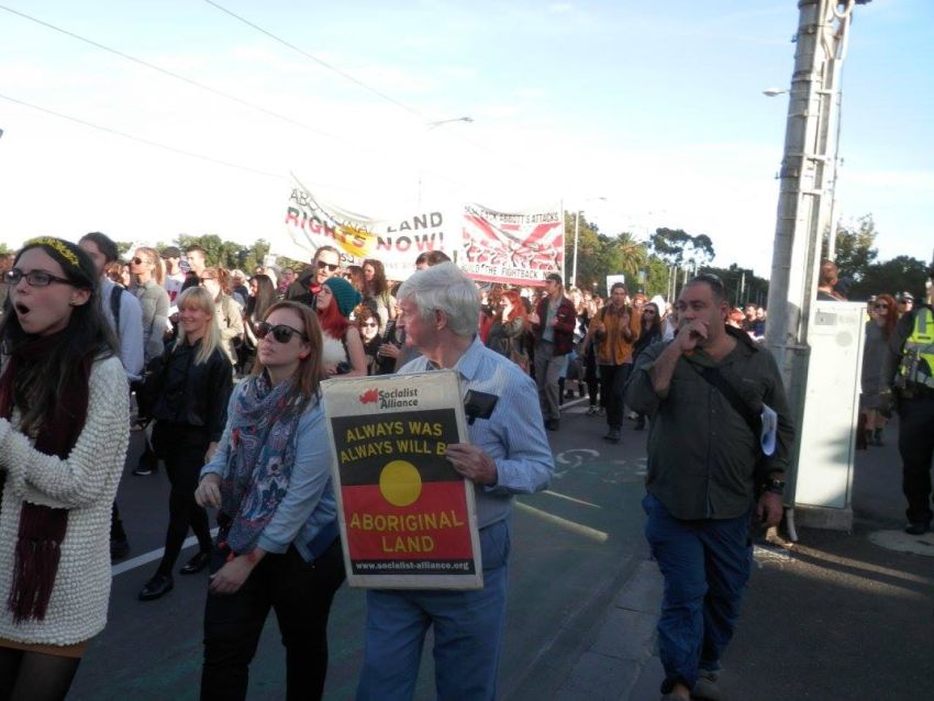 Protester holding Socialist Alliance placard at the rally.