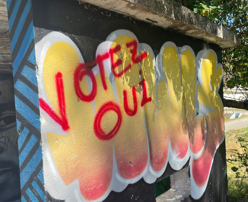 "Vote Yes" graffiti on a sign