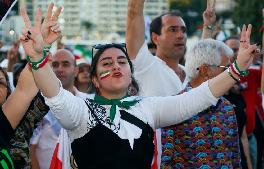woman making a peace sign with both hands