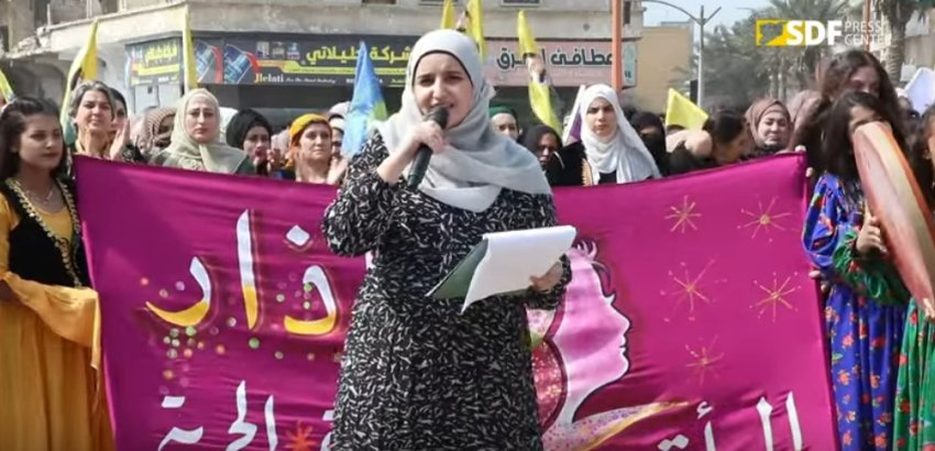 woman speaking at a rally for international womens day in Raqqa
