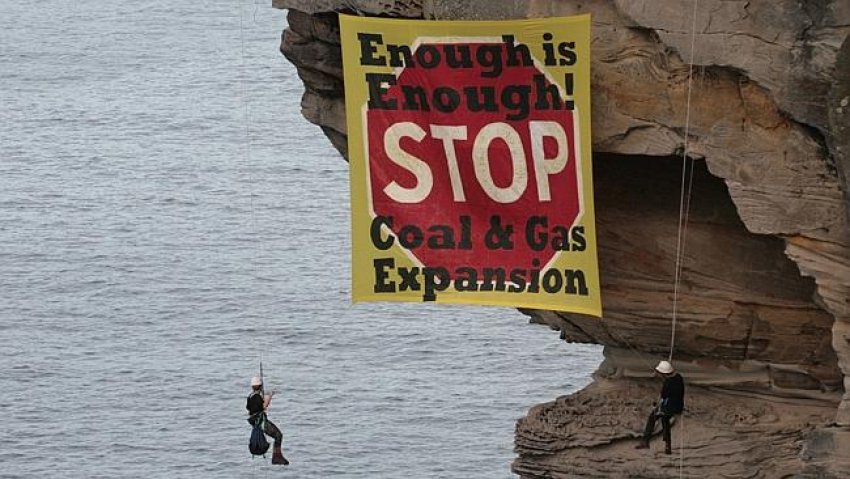 Activists dropped a banner on cliffs off Sydney’s North Head