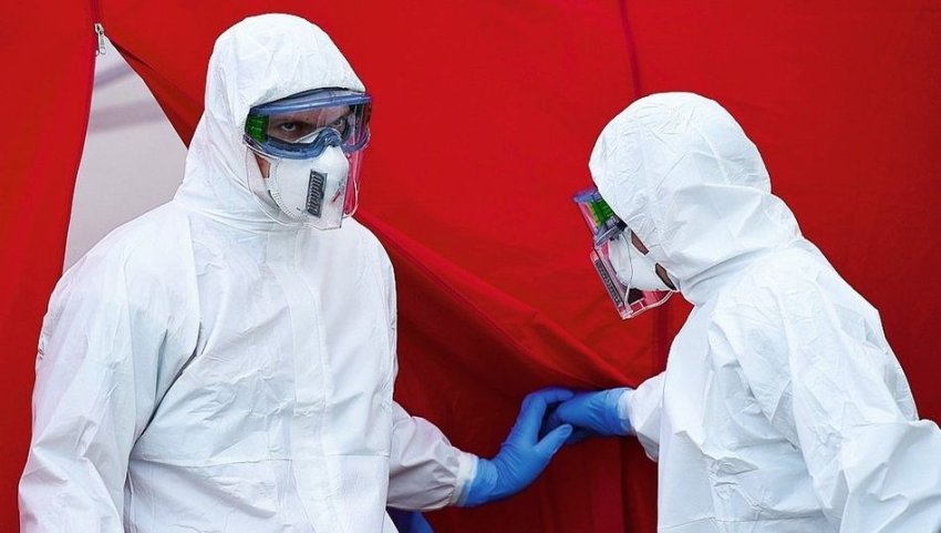 Medical workers at a coronavirus testing center in Dresden (Credit: Mattias Rietschel/Reuters)