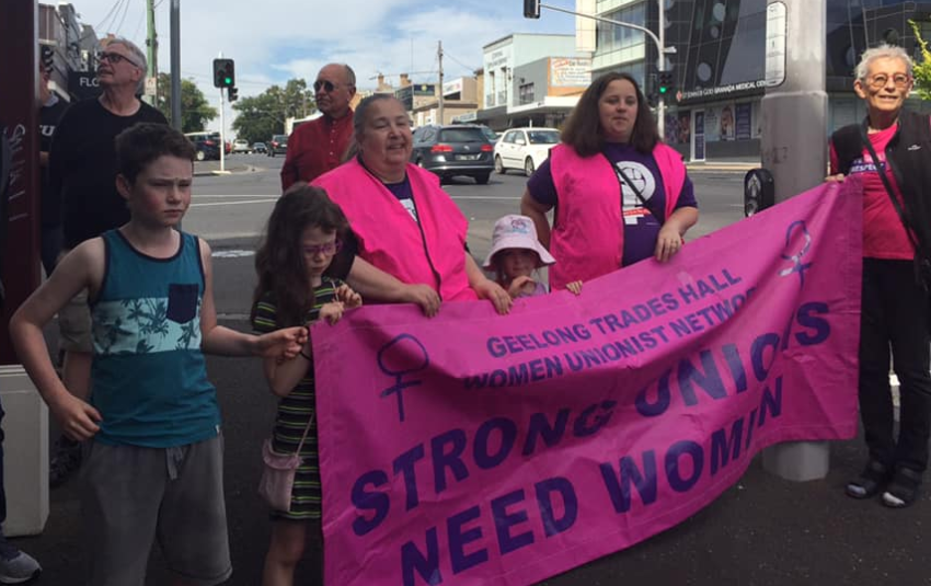 People hold sign that reads "Strong unions need women".