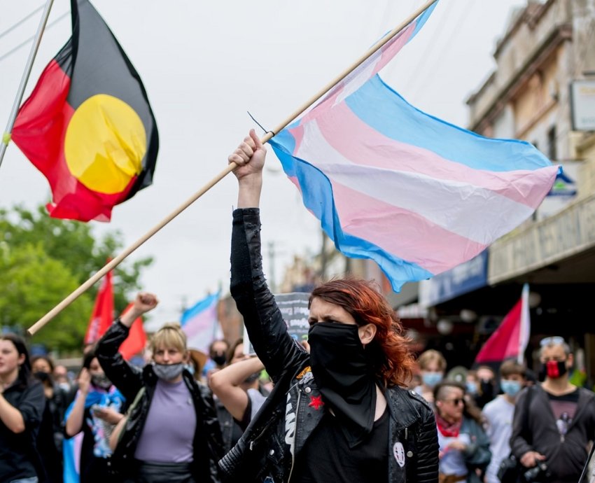 Protester holding trans flag