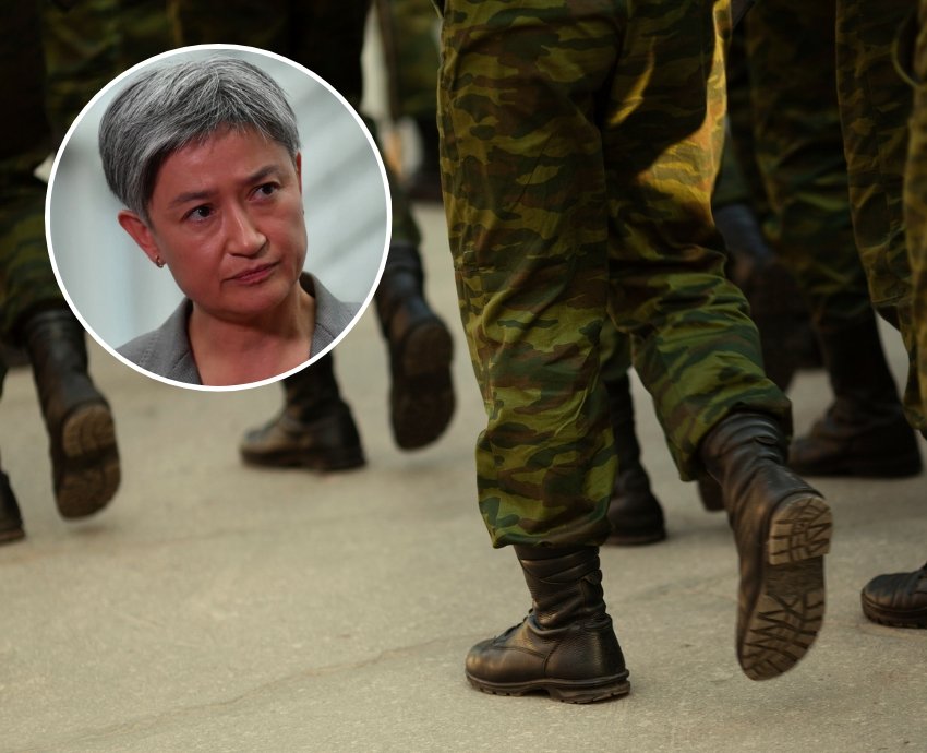Foreign Affairs Minister Penny Wong with background of soldiers