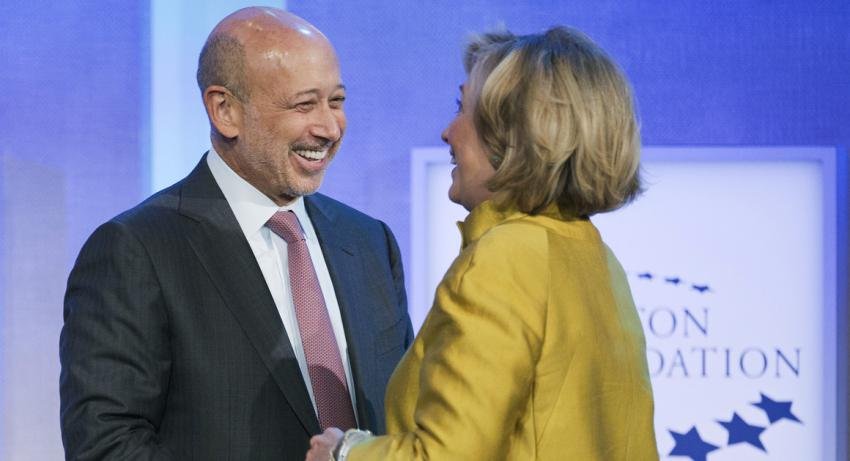 Goldman Sachs CEO Lloyd Blankfein shakes hands with Hillary Clinton
