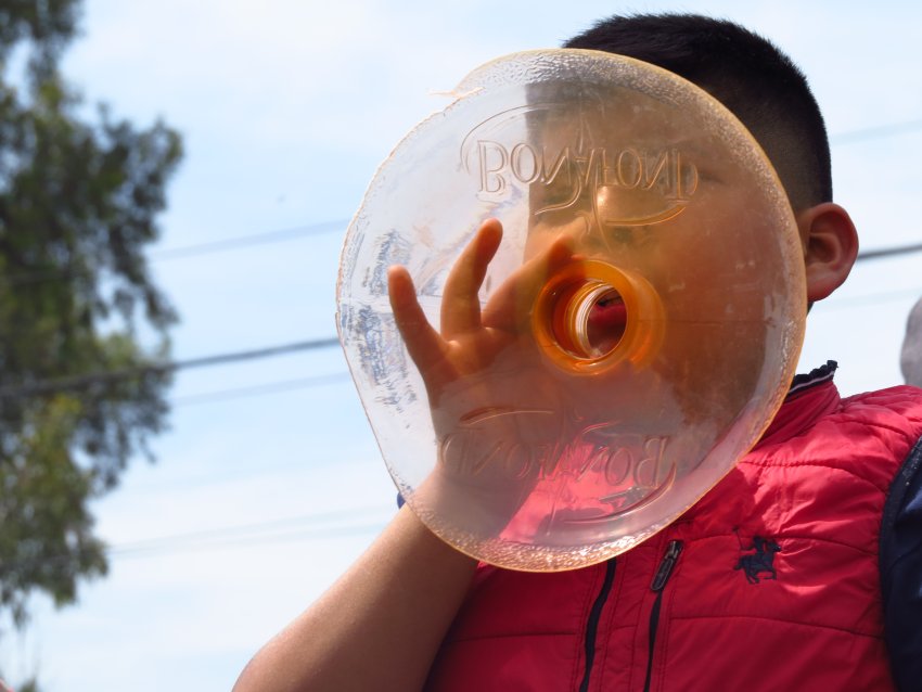 Boy chants using plastic water bottle 