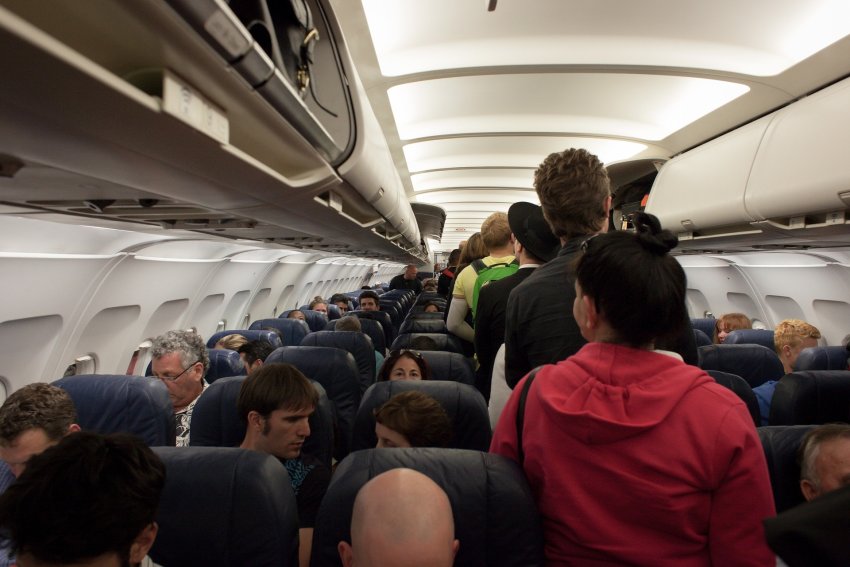 Passengers in a commercial aeroplane cabin.
