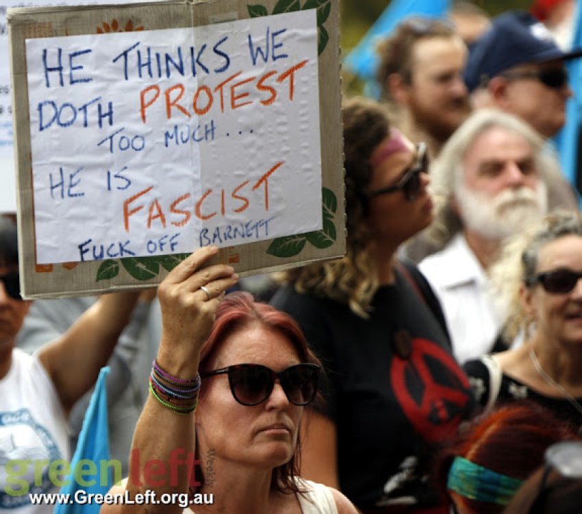 Protester with placard that reads 'He think we doth protest too much'