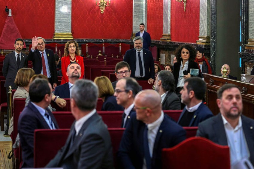 Catalan president Quim Torra greets the defendants