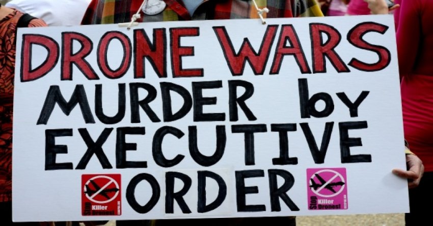 A placard condemns Obama's drone wars.