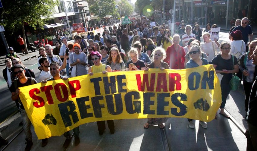 Stop the war on refugees banner at rally