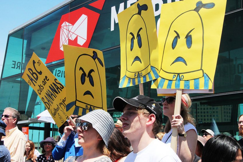 Angry Bananas in Pajamas on placards at rally against cuts