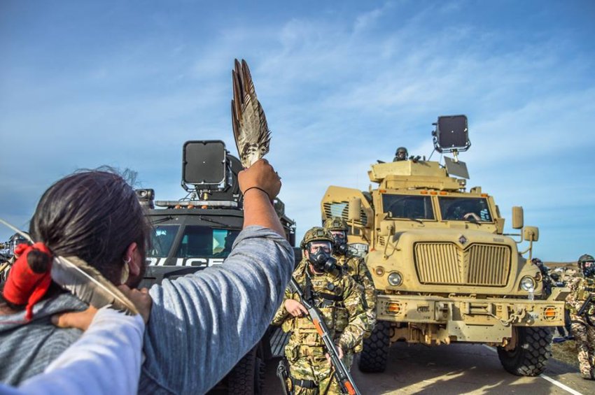 A water protector at Standing Rock defies the militarised police.