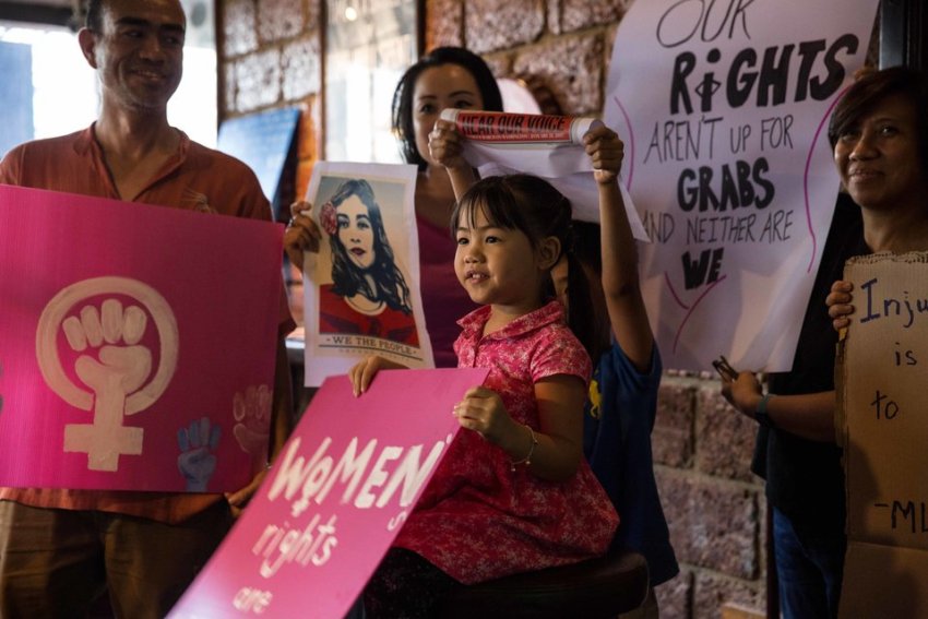 Protesters in Bangkok, Thailand hold women's rights placards as part of the global marches against Trump on January 21