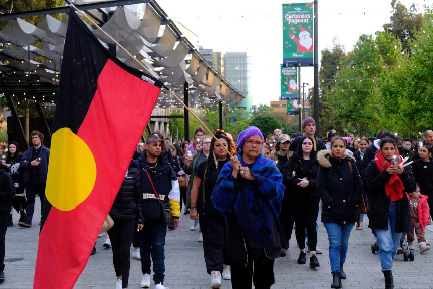 Marching with an Aboriginal flag at the Adelaide vigil for Cassis Turvey