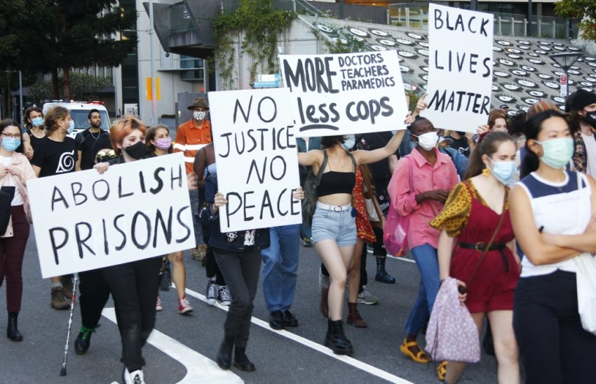 Signs in the march: No justice no peace