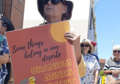 Protester holds up a sign opposing Vimy Resources' proposed uranium mine at Mulga Rock. 