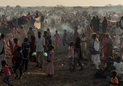 people arriving at a refugee camp