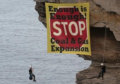 Activists dropped a banner on cliffs off Sydney’s North Head