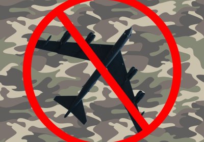 A B-52 bomber superimposed over a camouflage pattern, with a red No symbol
