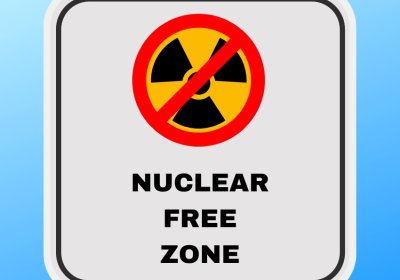 Sign with a no nuclear symbol that reads 'nuclear free zone'