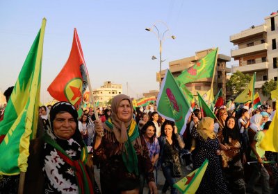 Demonstrators celebrate the anniversary of the Rojava Revolution.