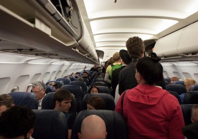 Passengers in a commercial aeroplane cabin.