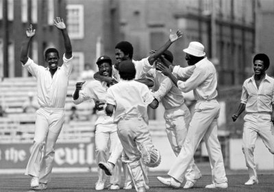 West Indian fast bowler Michael Holding celebrates the dismissal of Tony Greig