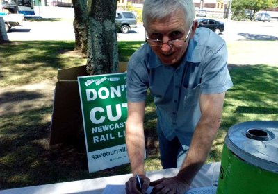 Steve O'Brien signs a petition to keep Newcastle's rail.