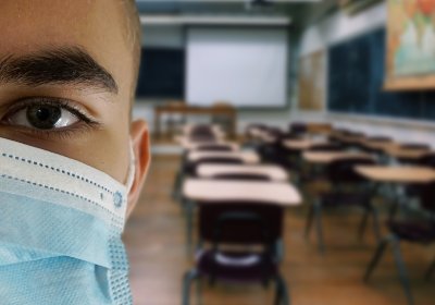 Child wearing a mask in a classroom