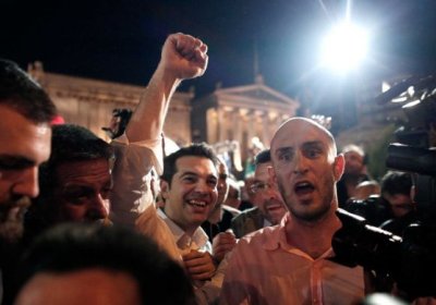 SYRIZA leader Alexis Tsipras, fist raised, celebrates with supporters on election night, May 6.