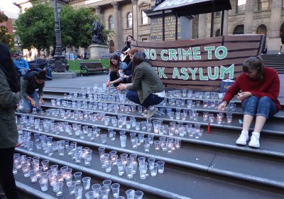 Candle lights at a vigil for refugee rights 