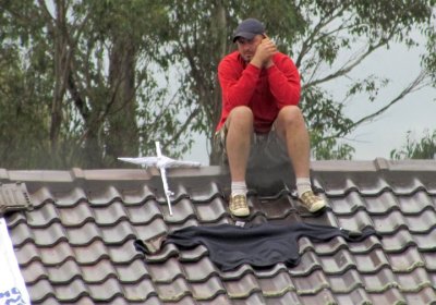 A refugee in Villawood detention centre takes part in a rooftop protest.