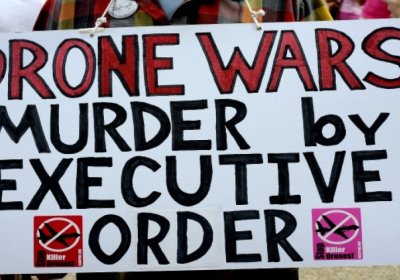 A placard condemns Obama's drone wars.