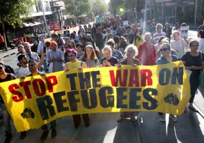 Stop the war on refugees banner at rally