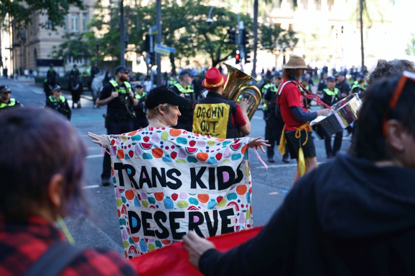 Counter protesters, police with transphobic rally in the background