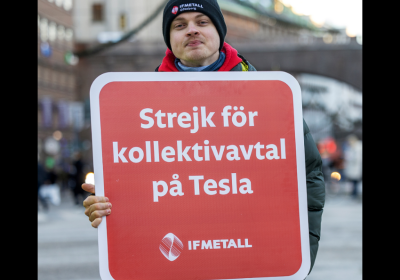 Striking worker holding a sign