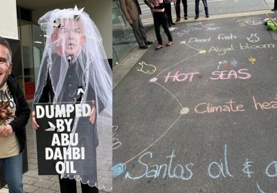 Extinction Rebellion protestors in costume and sidewalk chalk-up outside Santos office in Adelaide