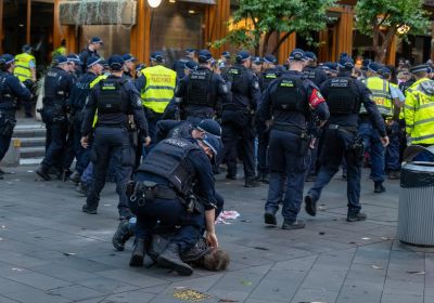 police pinning a protester to the ground