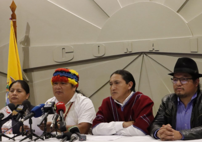 Four people speaking to a media conference